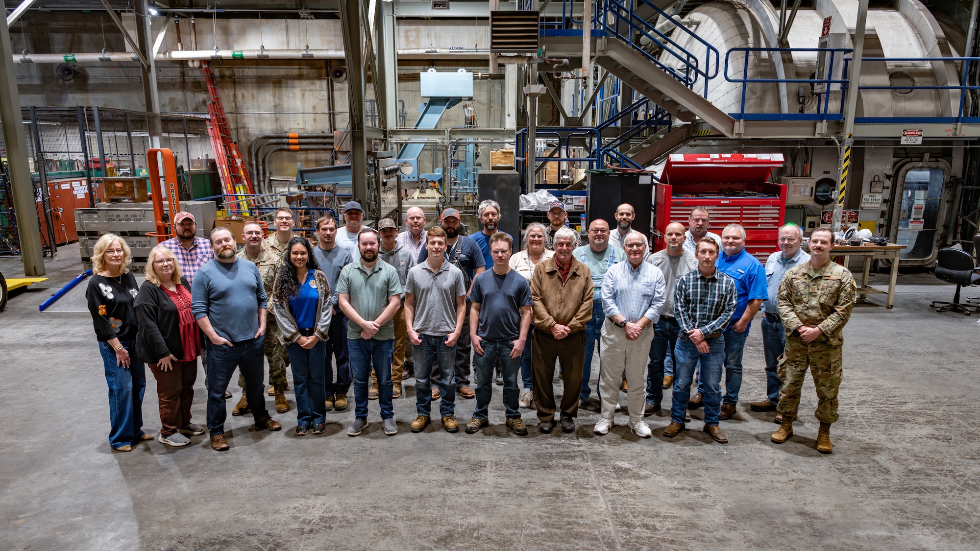 Members of the J-6 Rocket Motor Test Cell team at Arnold Air Force Base, Tenn., gather for a photo Oct. 8, 2024, around a month before the 150th test run was completed in the J-6 facility. J-6 is a large altitude test capability for medium to large rocket propulsion systems. Since its construction at Arnold AFB, headquarters of Arnold Engineering Development Complex, J-6 has fulfilled a national need by providing ground test simulations for large solid-propellant rocket motors over a wide range of simulated pressure altitudes and temperature conditions to replicate real-world scenarios. (U.S. Air Force photo by Keith Thornburgh)