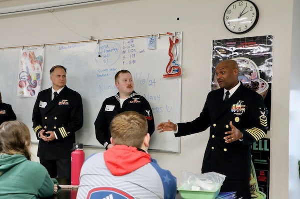 KANSAS CITY, Mo. (Nov. 13, 2024) Master Chief Hospital Corpsman Phillip Jean-Gilles, command master chief for Naval Medical Research Command (NMRC) and Navy Medicine representative, speak to an 11th grade class at North Kansas City High School class on the healthcare track during Navy Week Kansas City. Since 2005, America’s Navy has come home to up to 15 cities across the country every year. The Navy Week program has served as the Navy’s principal outreach effort into areas of the nation without a significant Navy presence, with over 300 Navy Weeks held in 95 different U.S. cities.



NMRC is engaged in a broad spectrum of activities, from basic science in the laboratory to field studies in austere and remote areas of the world to investigations in operational environments. In support of the Navy, Marine Corps, and joint U.S. warfighters, researchers study infectious diseases, biological warfare detection and defense, combat casualty care, environmental health concerns, aerospace and undersea medicine, medical modeling, simulation, operational mission support, epidemiology, and behavioral sciences. Navy Medicine – represented by more than 44,000 highly-trained military and civilian health care professionals – provides enduring expeditionary medical support to the warfighter on, below, and above the sea and ashore. (U.S. Navy photo by Hospital Corpsman 2nd Class Alejandra Ramirez Alarcon/Released)