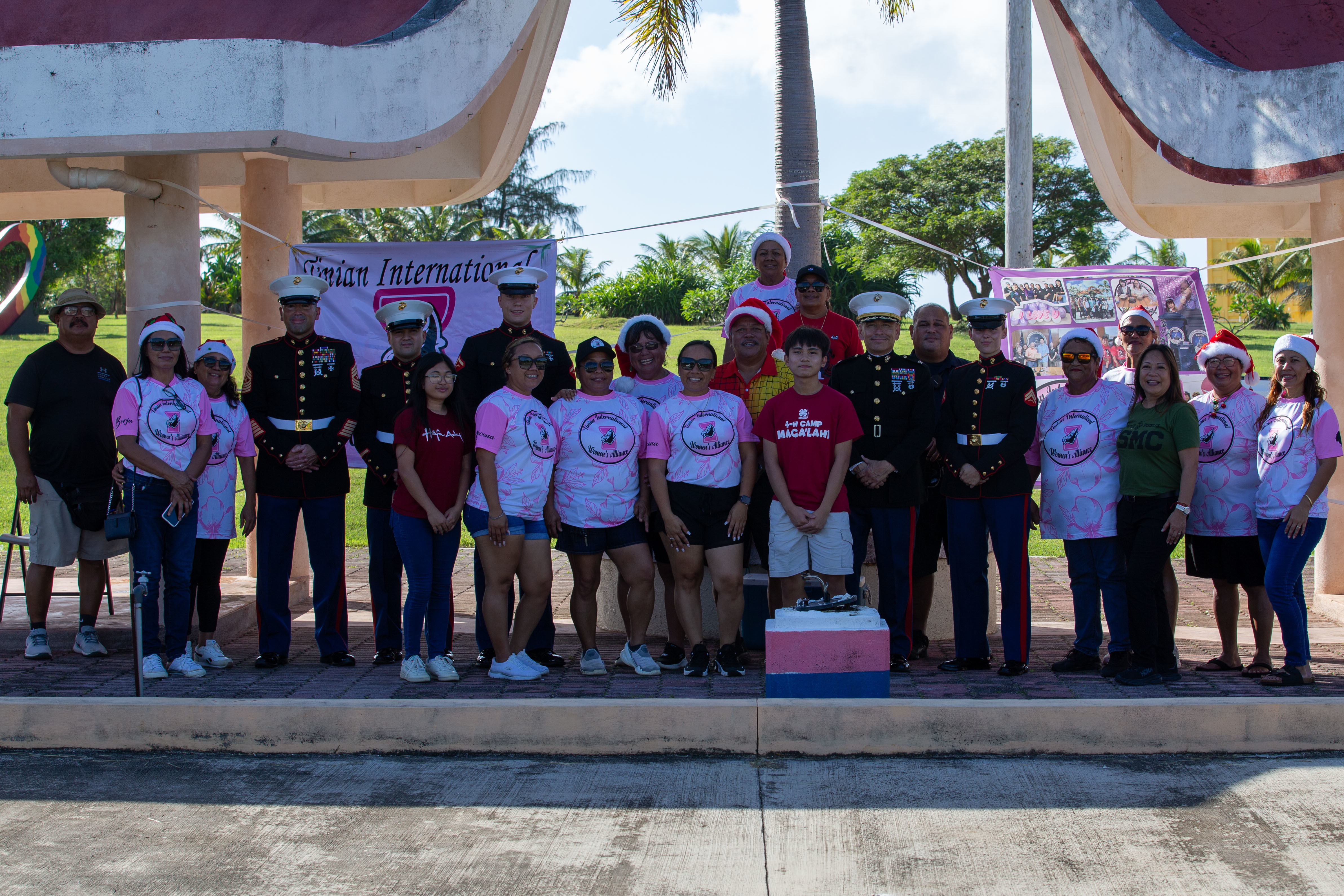 U.S. Marines with Marine Corps Base Camp Blaz, the Honorable Edwin P. Aldan, mayor of Tinian and Aguiguan, and volunteers with Tinian International Women's Alliance, pose for a photo during the distribution of toys for the Toys for Tots Campaign, San Jose, Tinian, Dec. 21, 2024. This year marks the 77th year of the national Marine Corps Toys for Tots Campaign and the 8th year in the Commonwealth of the Northern Mariana Islands. The mission of the Toys for Tots Program is to collect new, unwrapped toys and distribute those toys to children at Christmas. (U.S. Marine Corps photo by Lance Cpl. Afton Smiley)