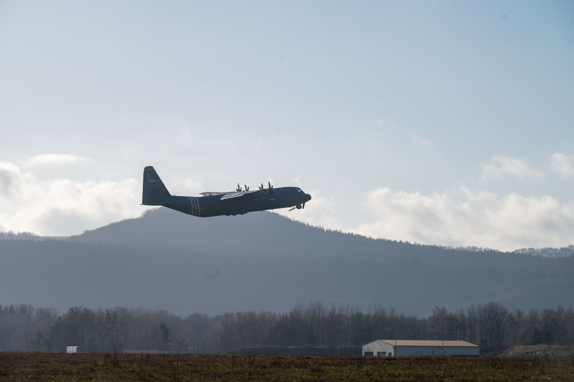 A C-130J plane takes off.
