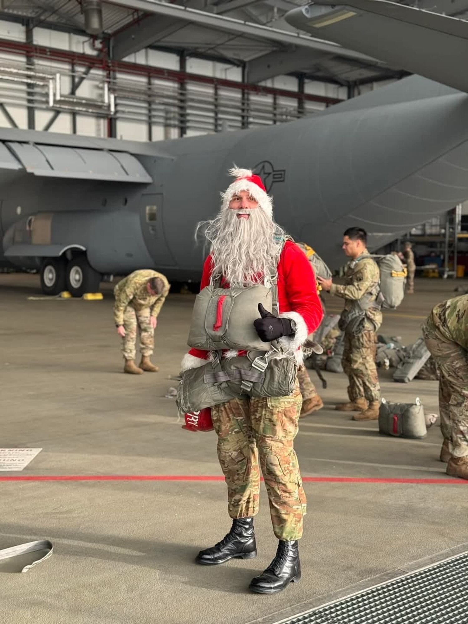 A man poses in a Santa costume.