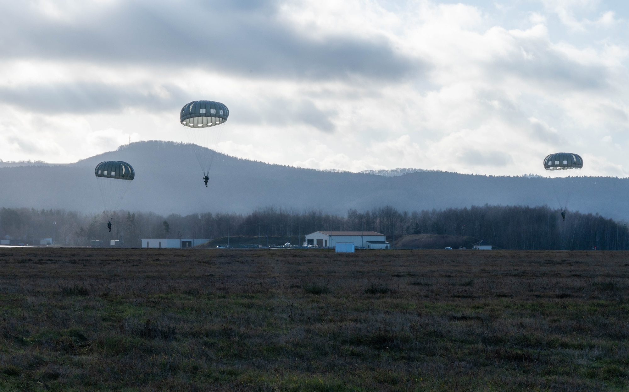 Airborne descend onto a drop zone.