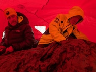 Ground rescuers aid stricken hiker Patrick Bittman inside a lightweight emergency shelter known as a Bothy Bag during a search and rescue Dec. 19, 2024, on Franconia Ridge.