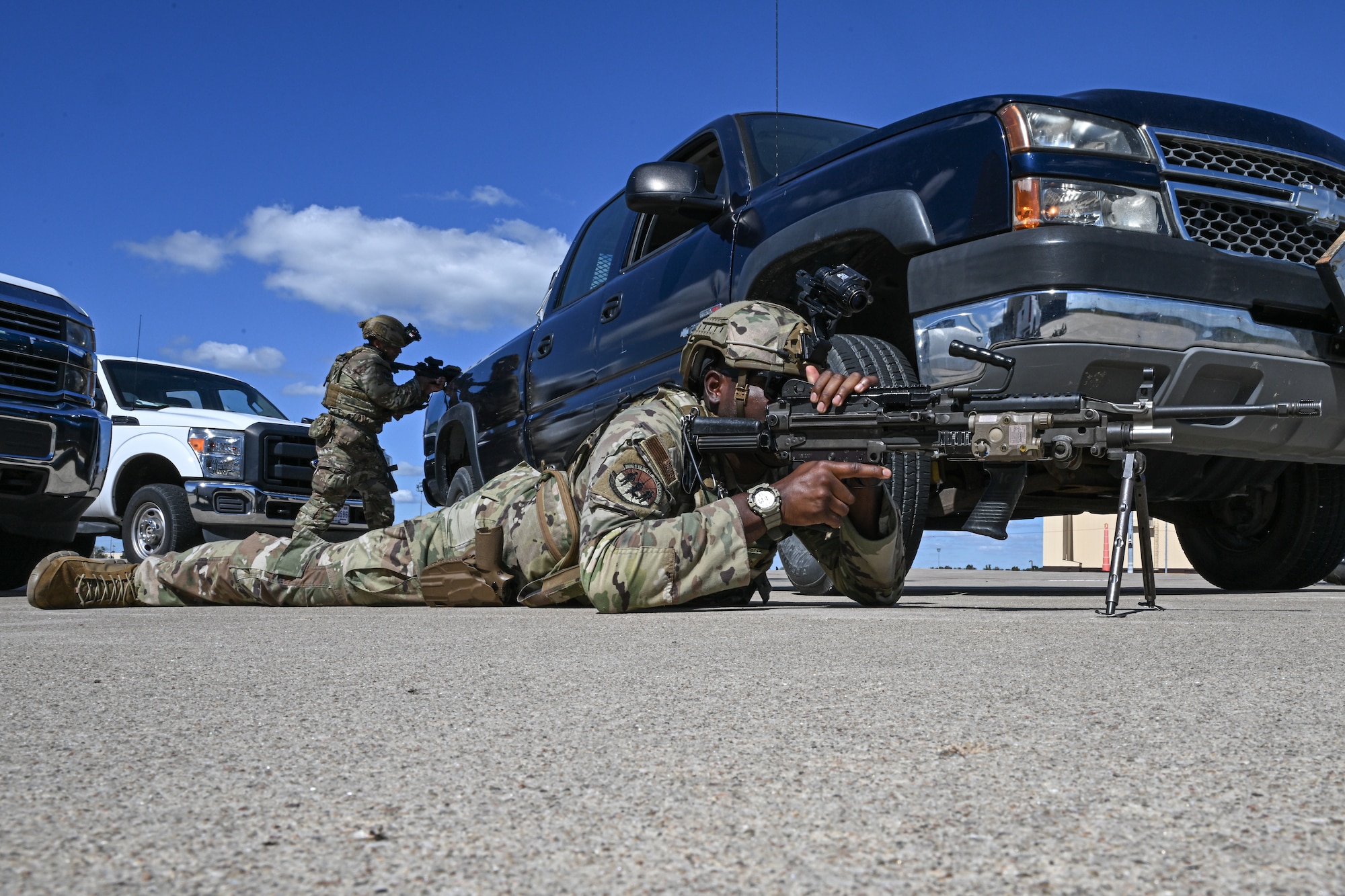 A U.S. Air Force Airmen assigned to the 509th Security Forces Squadron watches over other defenders as they conduct a routine exercise at Whiteman Air Force Base, Mo., Sept. 30, 2024. Defenders stay prepared by holding exercises regularly throughout the year, honing their skills and keeping them ready to fight (U.S. Air Force photo by Senior Airman Bryson Sherard)