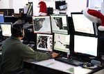 A New York Air National Guardsman assigned to the  Eastern Air Defense Sector in Rome, New York, prepares for NORAD Santa tracking operations. The annual NORAD Tracks Santa operation traces St. Nick's path around the world on Dec. 24.