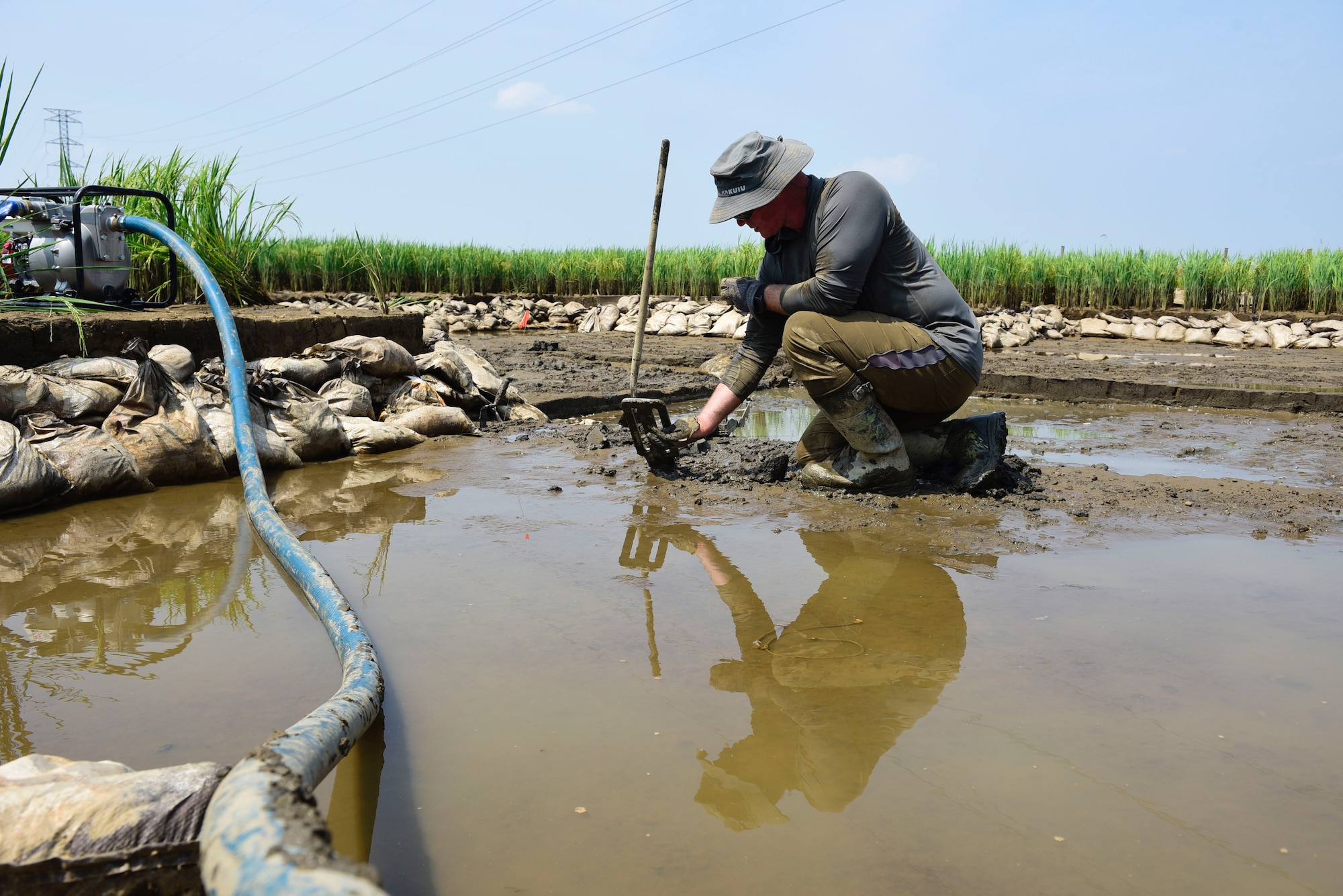 Master Sgt. Dustin Turner, right, an explosive ordnance disposal technician assigned to the Kentucky Air National Guard’s 123rd Civil Engineer Squadron, examines soil for osseous material in a rice paddy in Quang Binh Province, Vietnam, in June 2023. Turner was part of a U.S.-led team that recovered the remains of two U.S. Marine pilots who were lost in combat over Vietnam in December 1972.