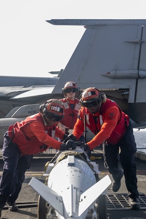 Sailors aboard the USS Harry S. Truman (CVN 75) prepare ordnance for strikes against Houthi targets in Yemen.