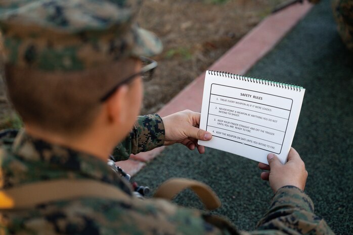 A U.S. Marine Corps recruit with Bravo Company, 1st Recruit Training Battalion, reviews the weapon safety rules during a grass week training event at Marine Corps Base Camp Pendleton, California, Dec. 18, 2024. Recruits endure numerous training hours over the course of a week, mastering their M16A4 service rifles and the fundamentals of marksmanship before moving on to live-fire drills. (U.S. Marine Corps photo by Cpl. Francisco Angel)