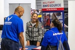 A recovering Airman and Caregiver talk with organizations during a resource fair held at the National Harbor, MD on 17 November 2024.