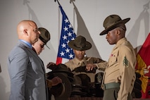 New U.S. Marine Corps drill instructor with DI school, receives his campaign cover for the first time during the Marine Corps Recruit Depot San Diego DI School 1-25 graduation ceremony at MCRD San Diego, California, Dec. 18, 2024. During DI school, Marines developed leadership skills, mastered drill, met physical fitness requirements and learned how to make Marines. Our Marines continue to serve their nation and their Corps through their lived examples of our values and by helping to identify and select potential recruits who may have what it takes to earn the title. (U.S. Marine Corps photo by Lance Cpl. Janell B. Alvarez)
