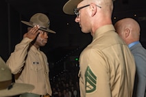 New U.S. Marine Corps Drill Instructor, Staff Sgt. Christopher Smith with drill instructor school, dons his campaign cover for the first time and salutes during the Marine Corps Recruit Depot San Diego Drill Instructor School 1-25 graduation ceremony at MCRD San Diego, California, Dec. 18, 2024. During DI school, Marines developed leadership skills, mastered drill, met physical fitness requirements and learned how to make Marines. Our Marines continue to serve their nation and their Corps through their lived examples of our values and by helping to identify and select potential recruits who may have what it takes to earn the title. (U.S. Marine Corps photo by Lance Cpl. Janell B. Alvarez)