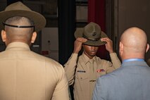 New U.S. Marine Corps Drill Instructor, Sgt. Reginald Seabrook with DI school, dons his campaign cover for the first time during the Marine Corps Recruit Depot San Diego DI School 1-25 graduation ceremony at MCRD San Diego, California, Dec. 18, 2024. During DI school, Marines developed leadership skills, mastered drill, met physical fitness requirements and learned how to make Marines. Our Marines continue to serve their nation and their Corps through their lived examples of our values and by helping to identify and select potential recruits who may have what it takes to earn the title. (U.S. Marine Corps photo by Lance Cpl. Janell B. Alvarez)