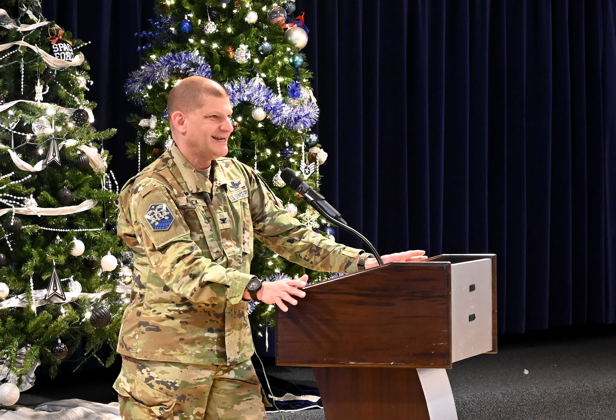 A Guardian speaks at a podium during a USSF 5th Anniversary celebration.