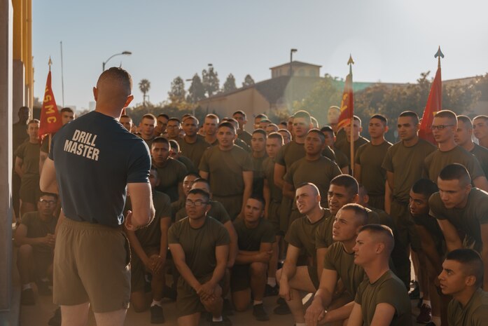 U.S. Marine Corps Drill Master Staff Sgt. Jake Landis, with 3rd Recruit Training Battalion, Recruit Training Regiment, left, speaks to the new Marines of Fox Company, 2nd Recruit Training Battalion, prior toward the motivational run at Marine Corps Recruit Depot San Diego, California, Dec. 19, 2024. The company motivational run is a three-mile cadence run conducted around the Depot and is the last physical training event the Marines will conduct before they graduate from MCRD San Diego. The event is also the first time friends and families will see their newly transformed Marines. The same fighting spirit that led Marines in the fight at Chapultepec, Belleau Wood, Iwo Jima, Okinawa, the Chosin Reservoir, Vietnam, in Fallujah and Marjah thrives in our Marines today. (U.S. Marine Corps photo by Lance Cpl. Janell B. Alvarez)