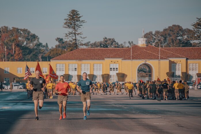 U.S. Marine Corps Regimental Drill Master, Gunnery Sgt. Kyle Wilton, left, Drill Master, Staff Sgt. Ulices Rodriguez, center, with 1st Battalion, Drill Master, Staff Sgt. Jake Landis, with 3rd Battalion, all with Recruit Training Regiment, lead the company motivational run for Fox Company, 2nd Recruit Training Battalion, at Marine Corps Recruit Depot San Diego, California, Dec. 19, 2024. The company motivational run is a three-mile cadence run conducted around the Depot and is the last physical training event the Marines will conduct before they graduate from MCRD San Diego. The event is also the first time friends and families will see their newly transformed Marines. The same fighting spirit that led Marines in the fight at Chapultepec, Belleau Wood, Iwo Jima, Okinawa, the Chosin Reservoir, Vietnam, in Fallujah and Marjah thrives in our Marines today. (U.S. Marine Corps photo by Lance Cpl. Janell B. Alvarez)