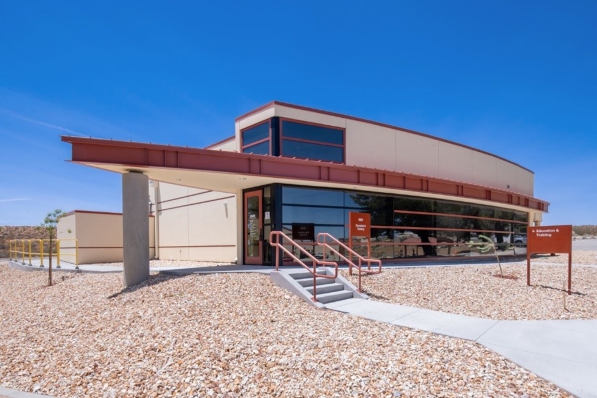 two story beige building with pebble stone surround