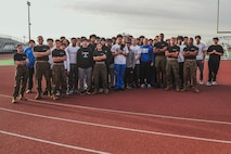 U.S. Marines with Recruiting Sub-Station Hemet, Recruiting Station San Diego, and members of the Beaumont High School football team, pose for a photograph during a weight room takeover at Beaumont High School in Beaumont, California, Dec. 16, 2024. A weight room takeover is an event where Marines engage with students in a gym setting, leading workouts and demonstrating fitness techniques as part of a community outreach or recruitment effort. (U.S. Marine Corps photo by Cpl. Alejandro Fernandez)