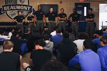 U.S. Marines with Recruiting Sub-Station Hemet, Recruiting Station San Diego, talk to students during a weight room takeover at Beaumont High School in Beaumont, California, Dec. 16, 2024. A weight room takeover is an event where Marines engage with students in a gym setting, leading workouts and demonstrating fitness techniques as part of a community outreach or recruitment effort. (U.S. Marine Corps photo by Cpl. Alejandro Fernandez)