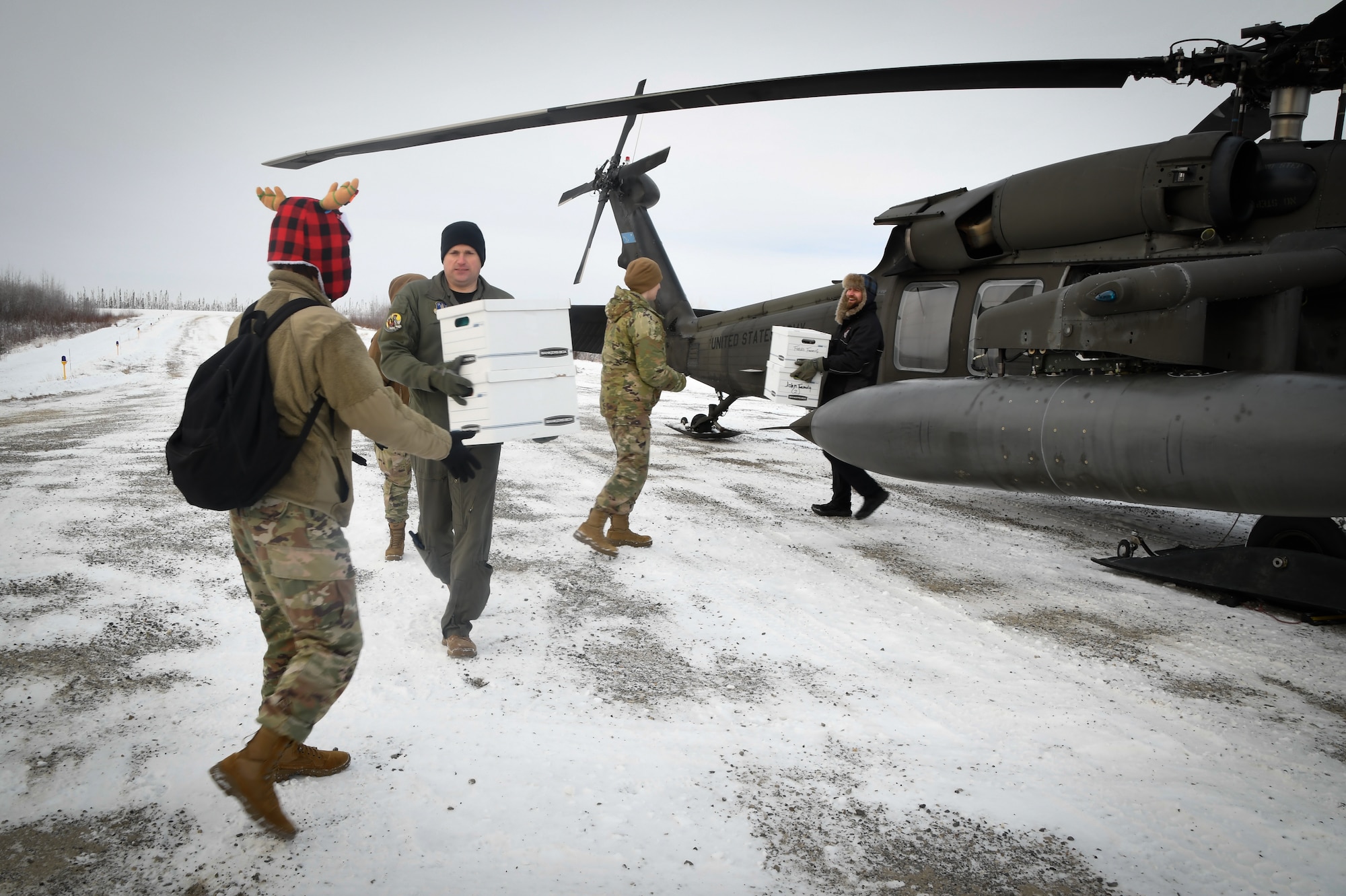he Salvation Army and members of the 168th Wing, Alaska Air National Guard, unload presents from an Alaska Army National Guard UH-60 Black Hawk.