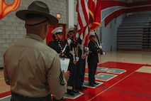 U.S. Marine Corps Staff Sgt. Aaron Placido, a drill instructor with Kilo Company, 3rd Recruit Training Battalion, Marine Corps Recruit Depot San Diego, evaluates cadets during a Junior Reserve Officer Training Corps drill competition at Sweetwater High School in National City, California, Dec. 7, 2024. The Junior Reserve Officer Training Corps drill competition is a formal event where cadets perform synchronized marching routines and precision drill to demonstrate discipline, teamwork and leadership skills. (U.S. Marine Corps photo by Cpl. Alejandro Fernandez)