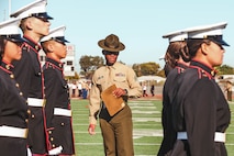 U.S. Marine Corps Sgt. Matthew Dailey, a drill instructor with Bravo Company, 1st Recruit Training Battalion, Marine Corps Recruit Depot San Diego, evaluates cadets during a Junior Reserve Officer Training Corps drill competition at Sweetwater High School in National City, California, Dec. 7, 2024. The Junior Reserve Officer Training Corps drill competition is a formal event where cadets perform synchronized marching routines and precision drill to demonstrate discipline, teamwork and leadership skills. (U.S. Marine Corps photo by Cpl. Alejandro Fernandez)