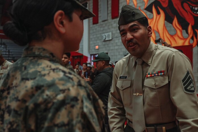 U.S. Marine Corps Staff Sgt. Aaron Placido, a drill instructor with Kilo Company, 3rd Recruit Training Battalion, Marine Corps Recruit Depot San Diego, inspects a cadet's uniform during a Junior Reserve Officer Training Corps drill competition at Sweetwater High School in National City, California, Dec. 7, 2024. The Junior Reserve Officer Training Corps drill competition is a formal event where cadets perform synchronized marching routines and precision drill to demonstrate discipline, teamwork and leadership skills. (U.S. Marine Corps photo by Cpl. Alejandro Fernandez)