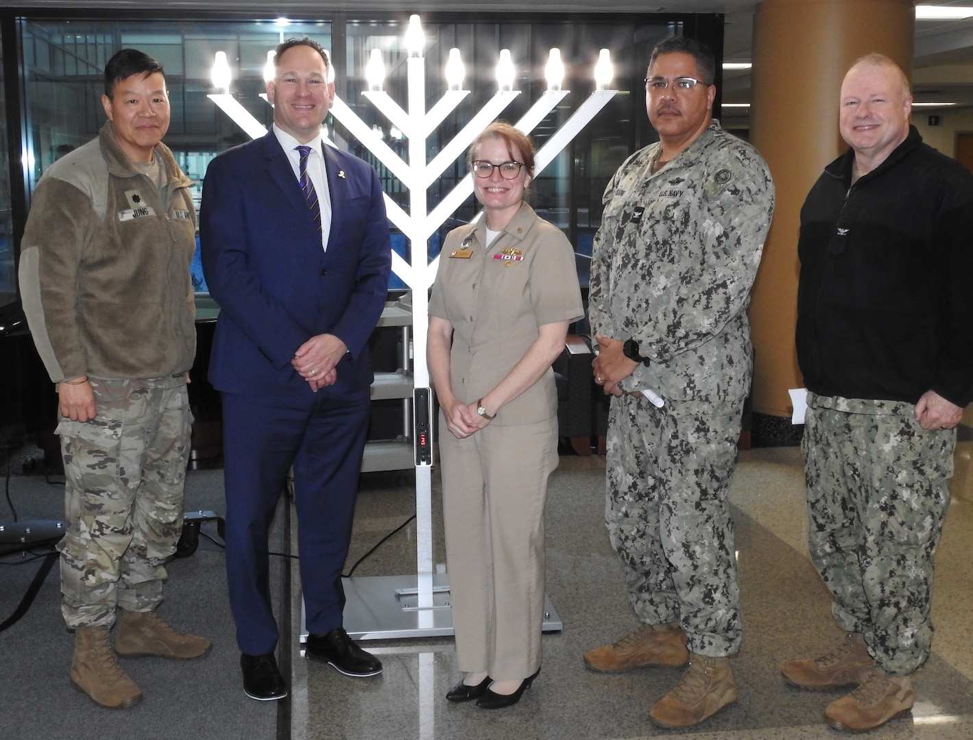 From left, U.S. Army Chaplain (Lt. Col.) Benjamin Jung, deputy chief of chaplains at Walter Reed, Rabbi Randy Brown, of the Department of Pastoral Care at Walter Reed, U.S. Navy CAPT (Dr.) Melissa Austin, Walter Reed director, U.S. Navy CAPT Juan Rosario, Walter Reed chief of staff, and U.S. Navy Chaplain (CAPT) Chris Hester, chief of chaplains at Walter Reed, participate in a Hanukkah educational program at Walter Reed on Dec. 19.