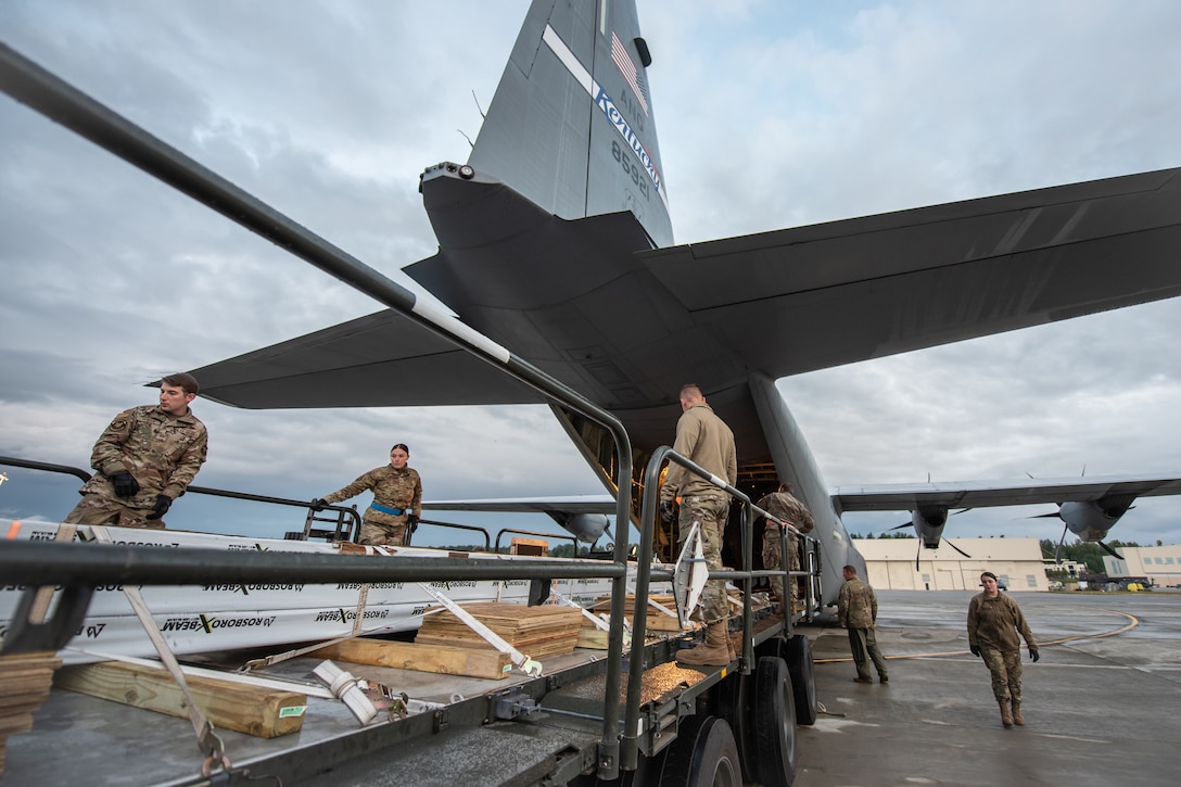 Members of the 123rd Airlift Wing upload cargo to a Kentucky Air National Guard C-130J Super Hercules aircraft in support of Operation Arctic Haven at Joint Base Elmendorf-Richardson, Alaska, Sept. 2, 2024.