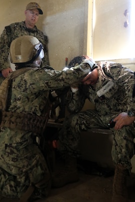 Lt. Kaitlin Walter evaluates a live actor patient involved in a motor vehicle accident for a possible head trauma while Capt. Chad Baasen observes during a training evolution on Bravo 1 Range conducted by Naval Expeditionary Medicine Warfighter Development Center (NEMWDC) on Dec. 16. Walter explains, “It was good getting immediate feedback from the actor. It’s an extra realistic simulation forcing me to have to pay more attention on the patient.” Walter is an Emergency Room Physician Assistant for Navy Medicine Readiness and Training Command (NMRTC) Camp Lejeune, N.C., set to deploy with her Expeditionary Resuscitative Surgical System team in Spring 2025.