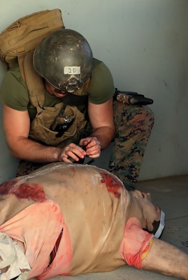 Hospital Corpsman 3rd Class (HM3) Ryan Baker applies a tourniquet on a high-fidelity simulated manikin at point-of-injuring during a training evolution as part Integrated Expeditionary Resuscitative Surgical System (ERSS) and En-route Care System (ERCS) course conducted by Naval Expeditionary Medicine Warfighter Development Center (NEMWDC) at Bravo 1 Range, Camp Pendleton, Dec. 16. Baker graduated from Basic Reconnaissance Course and is scheduled to attend the Special Operation Independent Duty Corpsman training.