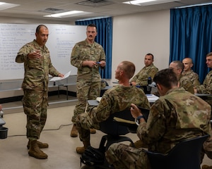 Warrant Officer Training School Class 25-01 warrant officer candidates discuss their plan for a team building exercise at Maxwell Air Force Base, Ala., Oct. 18, 2024.