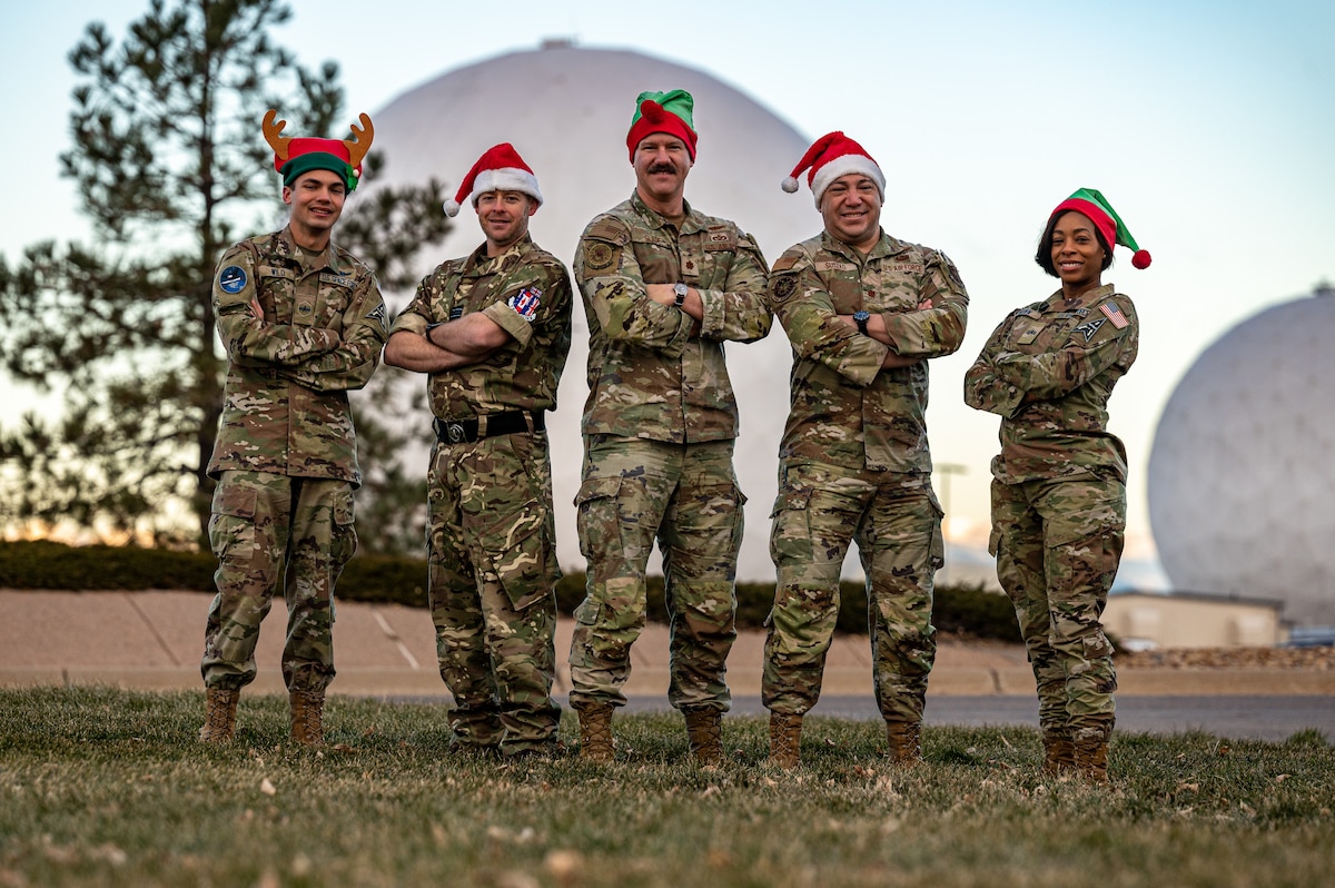 people in uniform standing with santa hats on