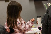 A Beale Air Force Base (AFB) dependent draws while she waits to track and talk to Santa during the 7th Space Warning Squadron's (7 SWS) Santa Tracker event at Beale AFB, California, Dec. 24, 2024.