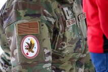 U.S. Space Force 1st Lt. Morgan Cisna, 7th Space Warning Squadron (7 SWS), wears a holiday variant of a 7 SWS patch during their annual Santa Tracker event at Beale Air Force Base, California, Dec. 24, 2024.