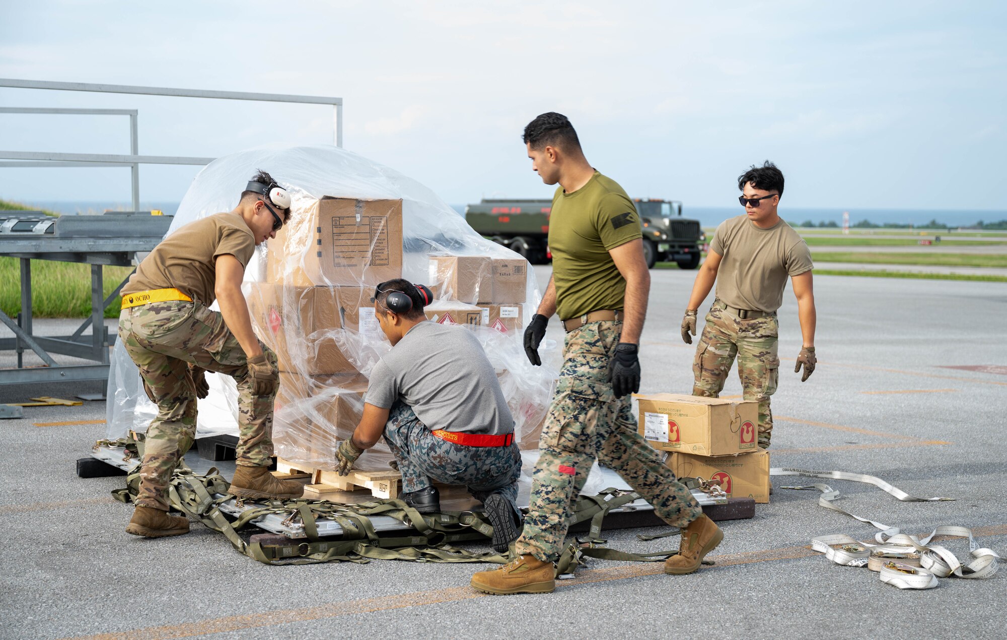 Service members pack cargo.