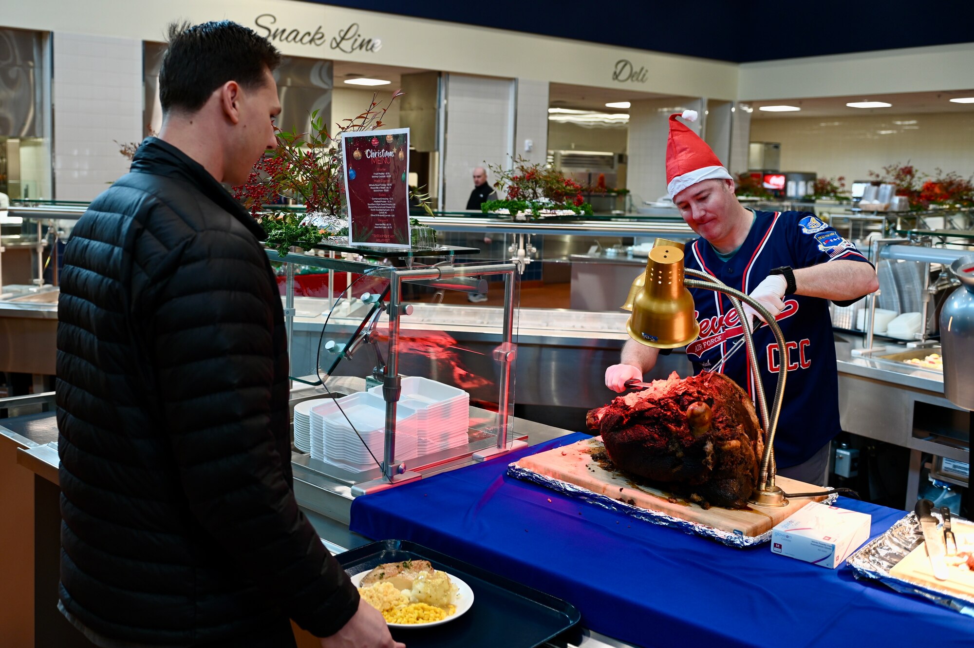 U.S. Air Force Chief Master Sgt. Jeremiah Ross, Seventh Air Force command chief, serves food to members assigned to the 8th Fighter Wing, during a holiday meal, at the O’Malley Dining Facility.