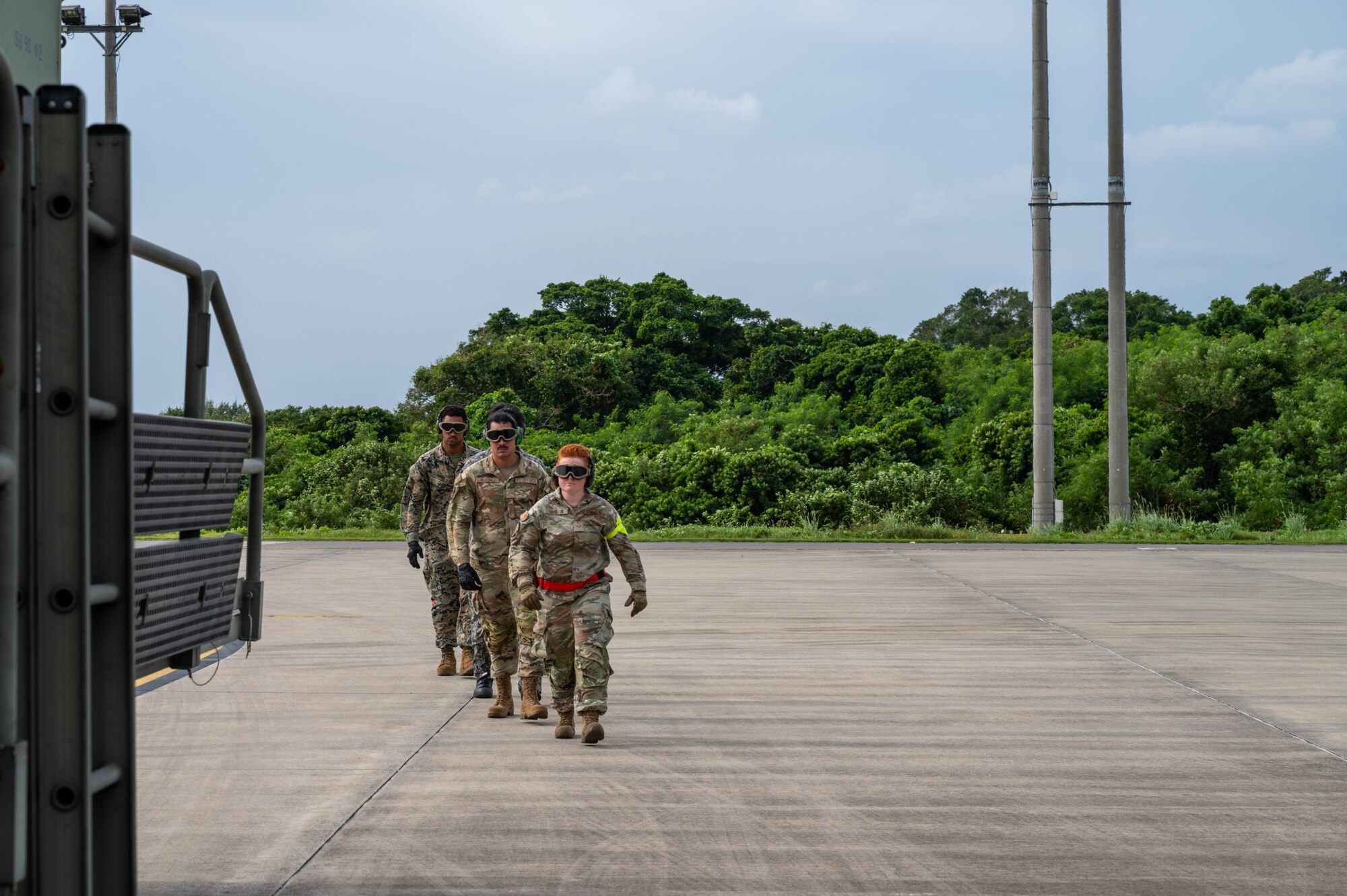 Service members walk toward cargo.