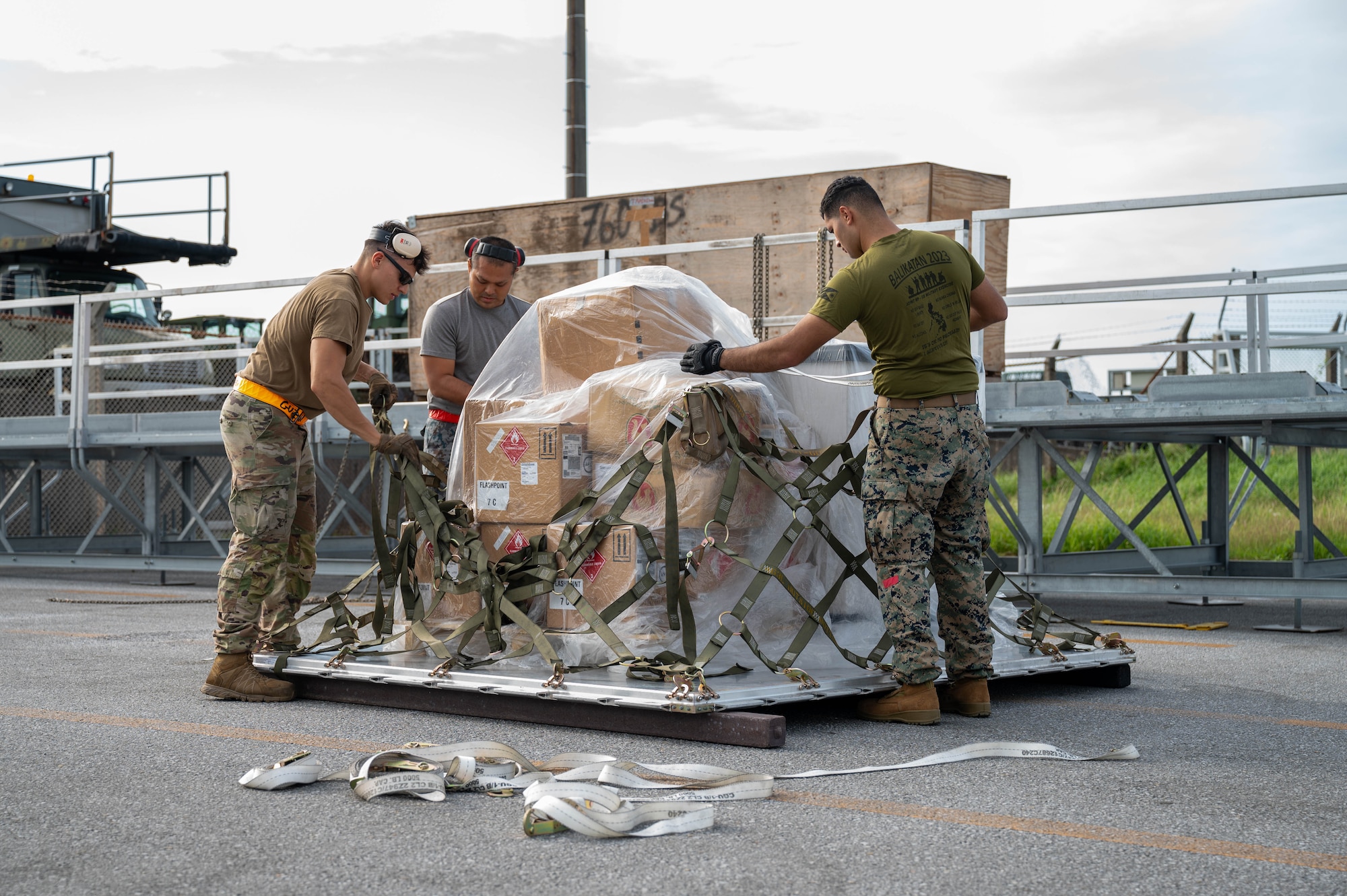 Service members pack cargo.