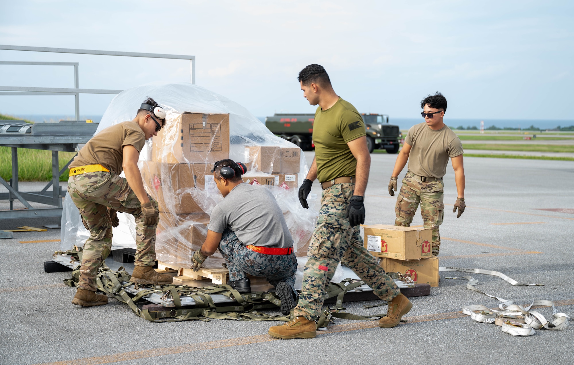 Service members pack cargo.