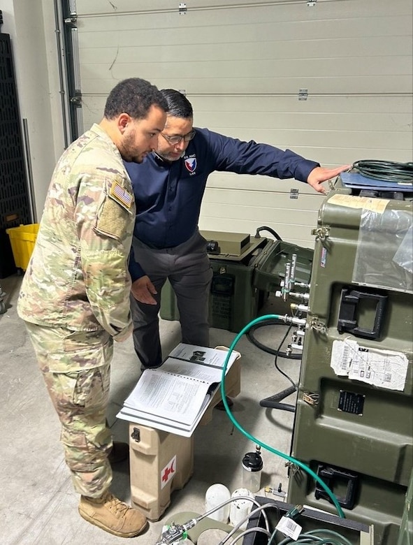 Vladimir Sequera, right, a systems technical representative with U.S. Army Medical Logistics Command’s Logistics Assistance Program, provides medical maintenance assistance and training to a Soldier during a site visit to Vicenza, Italy. The LAP, a worldwide program under AMLC’s Integrated Logistics Support Center, serves as a direct link between medical units and the AMLC enterprise, providing over-the-shoulder training and assistance to identify and address readiness issues in the field.