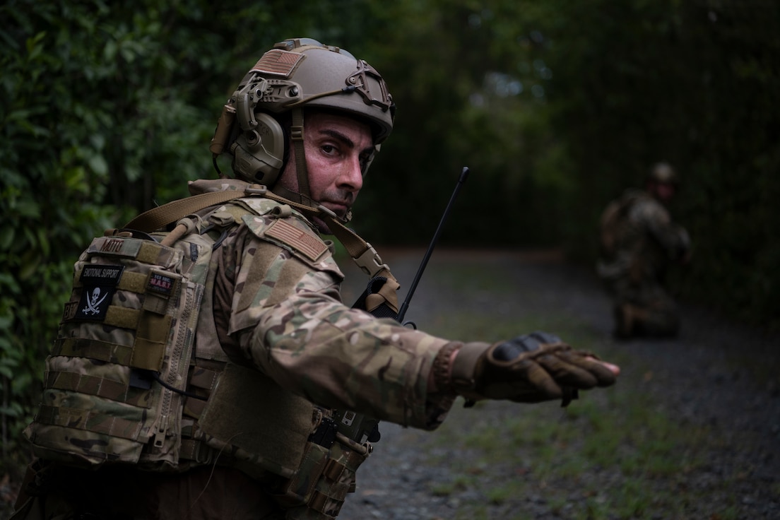 U.S. Air Force Staff Sgt. Yuri Motamedi, a security forces craftsman with the 123rd Contingency Response Group, Kentucky Air National Guard, signals airmen during an Air Base Ground Defense training at Muñiz Air National Guard Base, Carolina, Puerto Rico, Sept. 21, 2023.