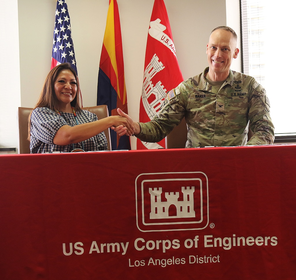 Tanya Lewis, chairwoman for the Yavapai-Apache Nation in Arizona, left, and Col. Andrew Baker, commander of the U.S. Army Corps of Engineers Los Angeles District, right, shake hands after signing a project agreement Dec. 16 for design and construction assistance for the Yavapai-Apache Nation Wastewater Treatment Plant in Arizona. The project aims at providing a sustainable treatment method that will improve the overall health, sanitation and security for the Yavapai-Apache Nation, the environment and all communities that rely on the Verde River.