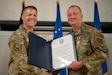 Chief Master Sgt. Gregory Myers, right, 123rd Security Forces Squadron manager, receives his certificate of retirement from Lt. Col. Jason Ray, former 123rd SFS operations officer, during a ceremony at the Kentucky Air National Guard Base in Louisville, Ky., Oct. 13, 2024. Myers is retiring after 30 years of service to the active-duty Air Force and Air National Guard. (U.S. Air National Guard photo by Master Sgt. Joshua Horton)