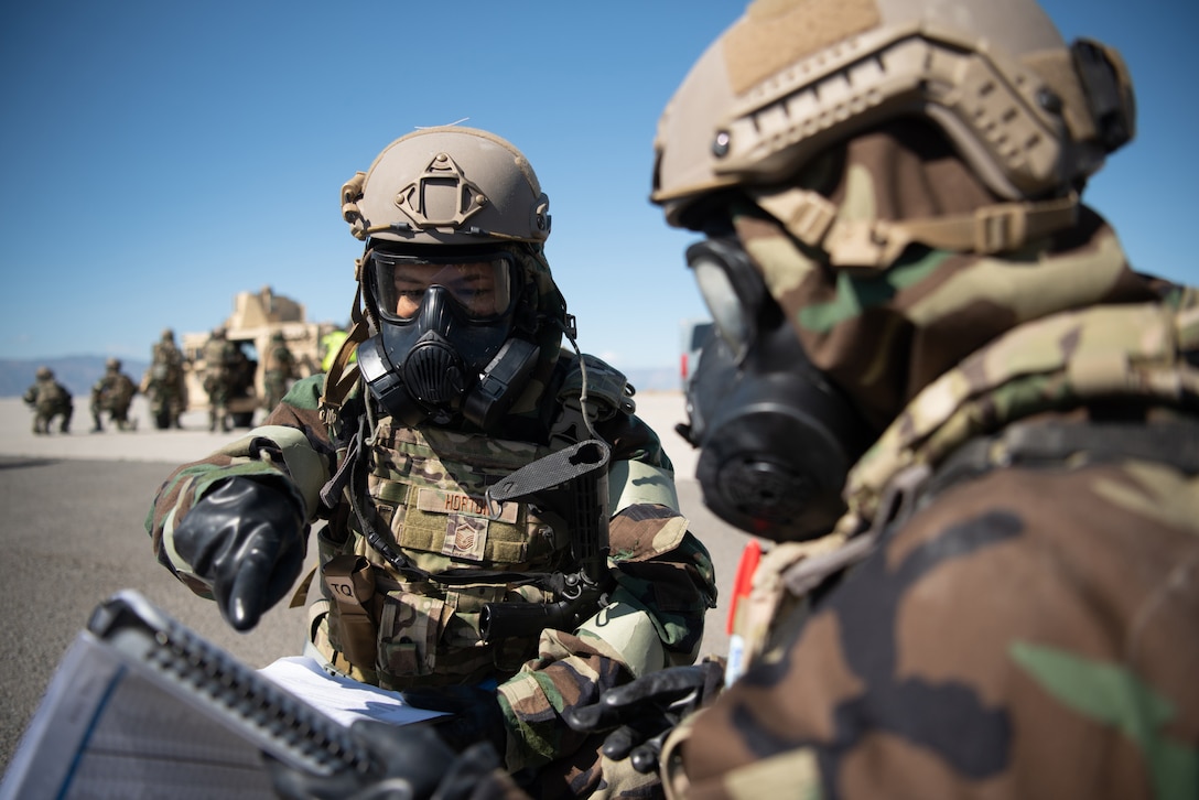 Master Sgt. Lindsey Horton, left, an Airman assigned to the Kentucky Air National Guard’s 123rd Contingency Response Group, performs an accountability check after a simulated attack at Amedee Army Airfield, Calif., Aug. 25, 2024, as a part of a U.S. Transportation Command exercise to revalidate the 123rd CRG’s capability to lead a Joint Task Force-Port Opening.