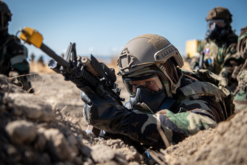 Master Sgt. Travis Greenwell, an Airman from the Kentucky Air National Guard’s 123rd Contingency Response Group, responds to a simulated attack after donning a chemical warfare ensemble at Amedee Army Airfield, Calif., Aug. 25, 2024, as a part of a U.S. Transportation Command exercise to revalidate the 123rd CRG’s capability to lead a Joint Task Force-Port Opening.