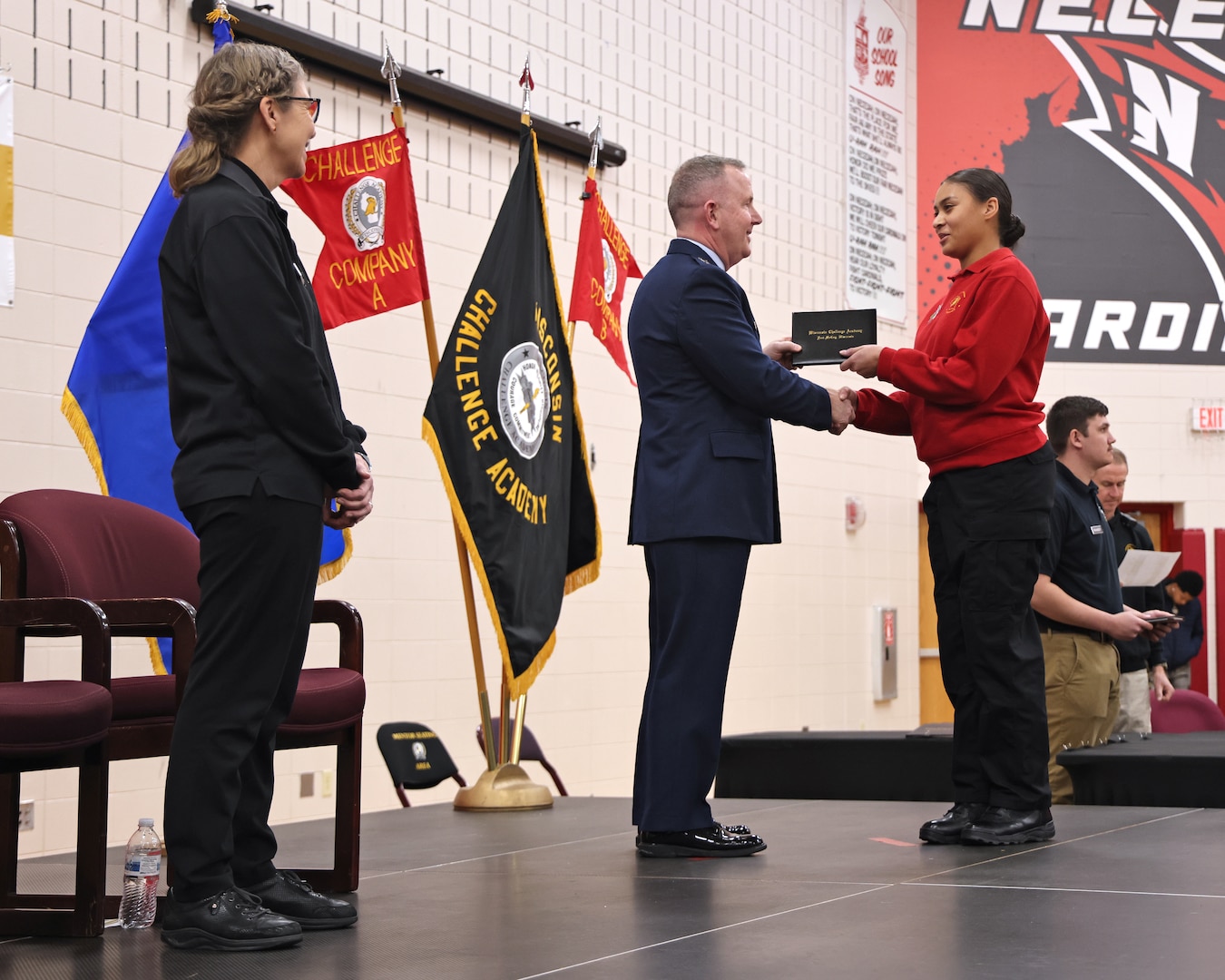 U.S. Air Force Brig. Gen. David May, interim adjutant general for the Wisconsin National Guard, presents graduation certificates to 86 cadets of the Wisconsin National Guard Challenge Academy's class 53, December 21, 2024, at Necedah High School in Necedah, Wisconsin.