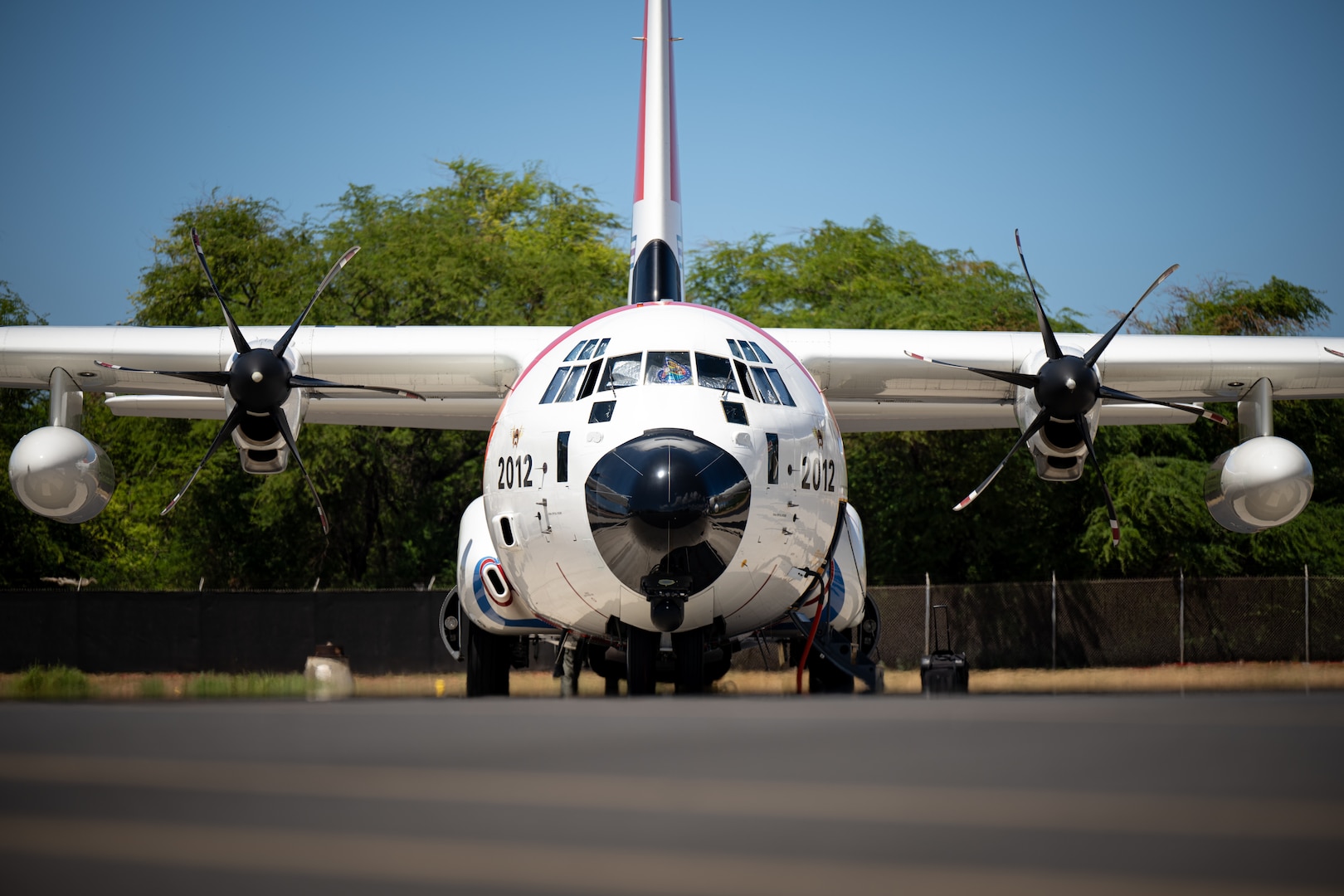 A U.S. Coast Guard HC-130J Hercules aircraft parked on the flightline at Air Station Barbers Point, Oahu, HI, Aug. 15, 2024. This aircraft is used for search and rescue missions, maritime patrol, and logistical operations. (U.S. Air National Guard photo by Staff Sgt. Joseph Pagan).