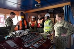 WILHELMSHAVEN, Germany (Dec. 20, 2024) Strategic Sealift Officer, Lt. j.g. Christian Tanas, left, a Tactical Advisor from Military Sealift Command (MSC) assigned to the MSC contracted vessel MV Sagamore discusses navigation principles with members of MSC's Expeditionary Port Unit on Sagamore's bridge while the ship is moored pier side in Wilhelmshaven, Germany Dec. 20. (U.S. Navy photo by Ben Farone)