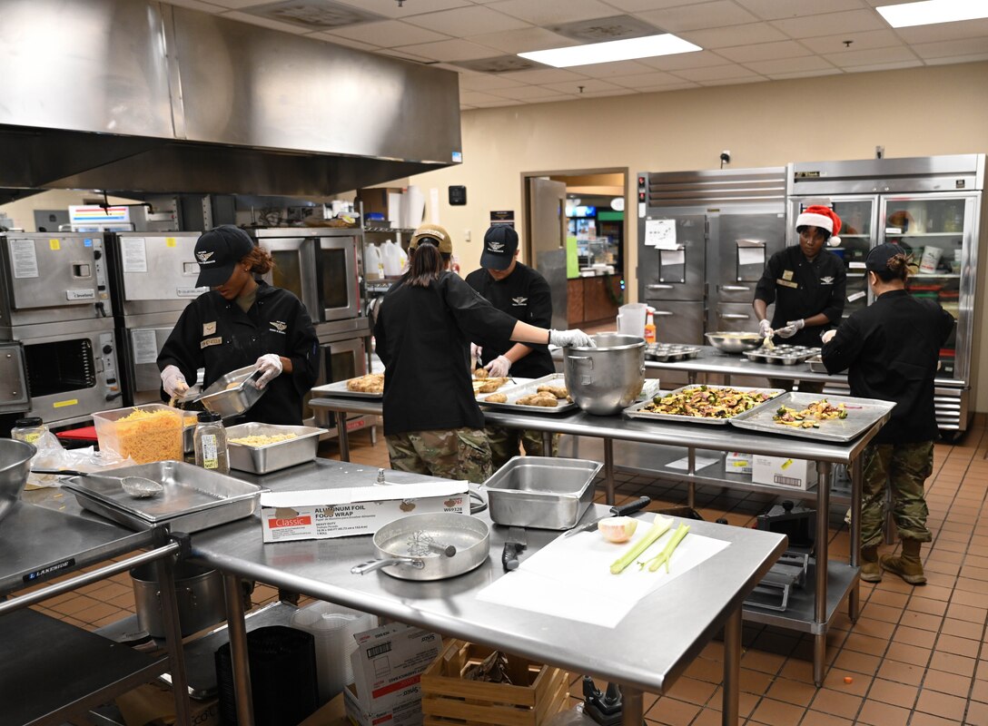 Food services Airmen prepare food in kitchen