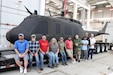 Members of the Letterkenny Army Depot Directorate of Industrial Operations Process Support Division pose in front of a completely repainted Vietnam era UH-1 Iroquois ‘Huey’ helicopter at the depot on Nov. 17, 2024. LEAD team members worked together to provide support to Fort Indiantown Gap’s static display area. Along with the Huey, artisans completed on-site paint repair on two other aircrafts, an AH-1 Cobra and an OH-6 Cayuse, also known as a Loach. (U.S. Army photo by Pam Goodhart)